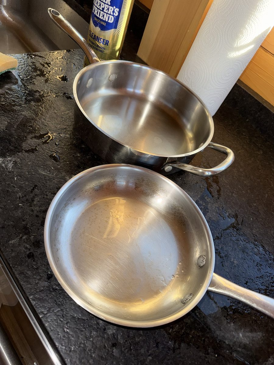 After: the same two stainless steel pans scrubbed clean and shining