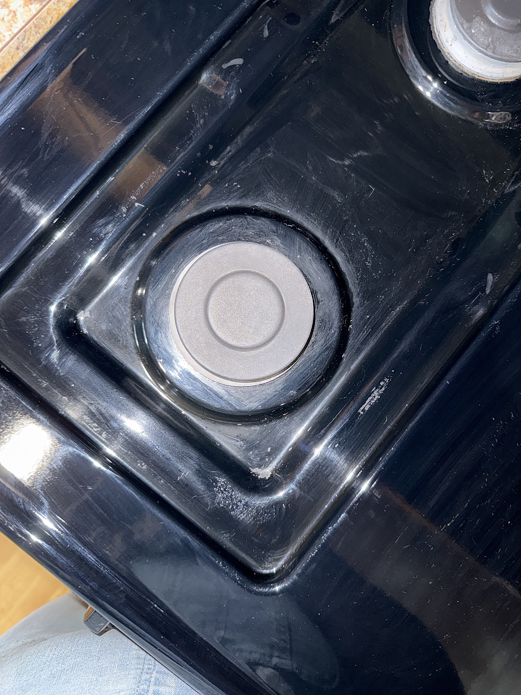 After: the same black stovetop burner wiped clean and shining