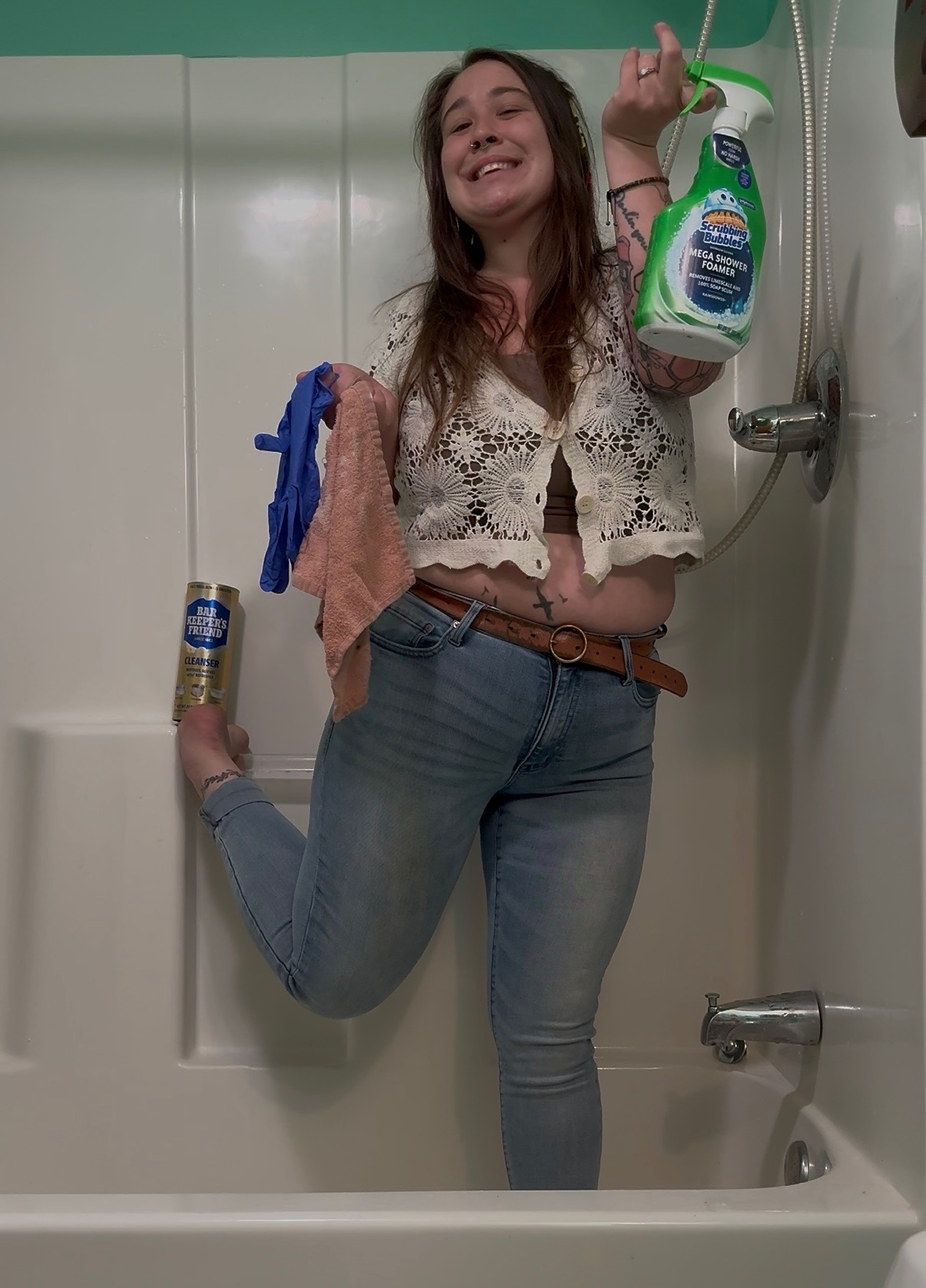 Tinora, owner of Northern Peaks Cleaning, holding her cleaning supplies